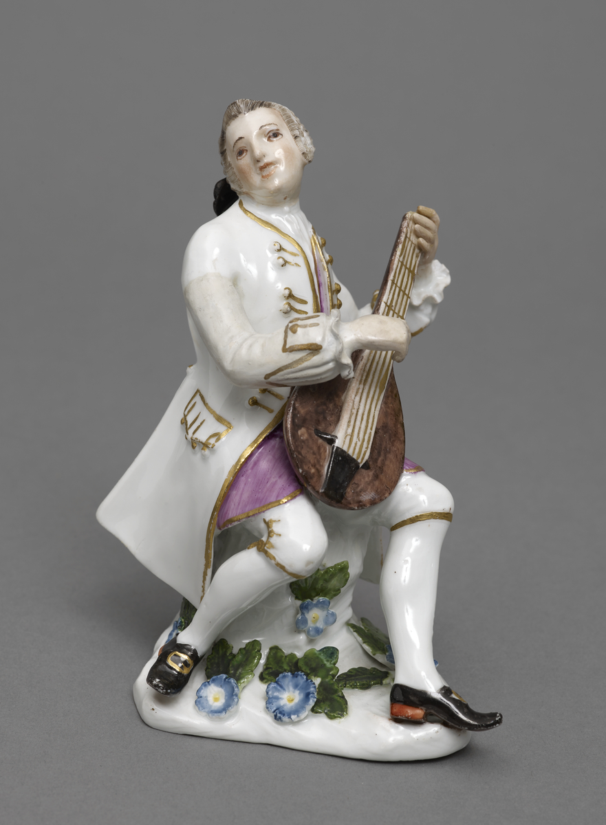 figure of a man playing a lute